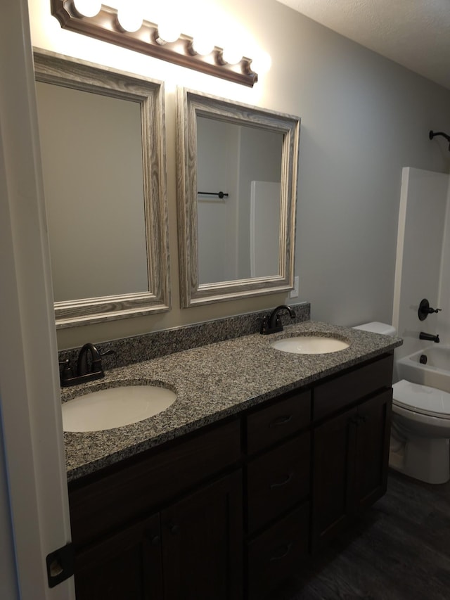 4070 Hartsville Rd, Lafayette, TN 37083 - bathroom with double vanity, tub / shower combination, and wood finished floors