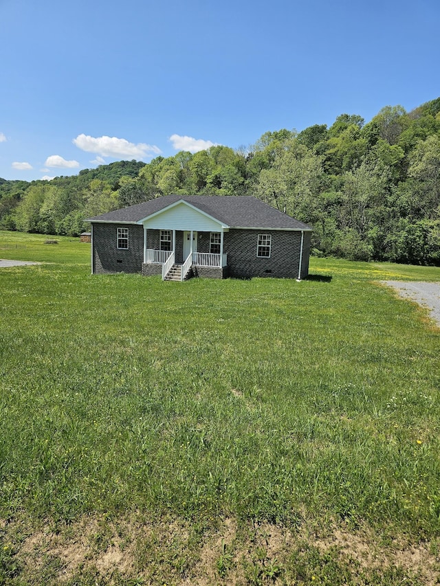 4070 Hartsville Rd, Lafayette, TN 37083 - ranch-style house featuring a porch, a front lawn, and a view of trees