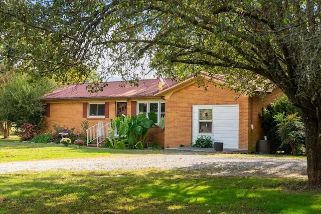 69 Prospect Rd E, Fayetteville, TN 37334 - ranch-style home with brick siding, a front yard, and a metal roof