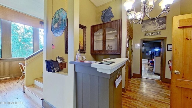 329 Wheeler Ln, Jamestown, TN 38556 - corridor with wood finished floors, a chandelier, and stairway