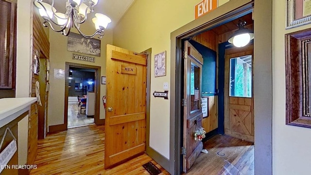 329 Wheeler Ln, Jamestown, TN 38556 - hall featuring light wood-style floors, a chandelier, and vaulted ceiling