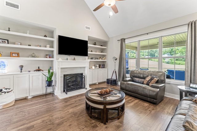 1446 Millstone Creek Rd, Lascassas, TN 37085 - living area featuring ceiling fan, high vaulted ceiling, wood finished floors, a high end fireplace, and built in shelves