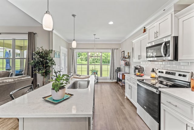 1446 Millstone Creek Rd, Lascassas, TN 37085 - kitchen featuring stainless steel appliances, light wood-style floors, white cabinets, an island with sink, and backsplash