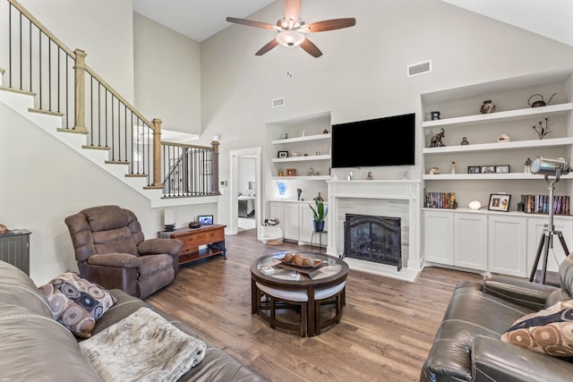 1446 Millstone Creek Rd, Lascassas, TN 37085 - living area featuring high vaulted ceiling, a ceiling fan, wood finished floors, stairway, and a premium fireplace