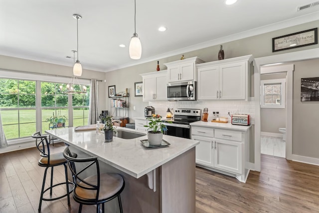 1446 Millstone Creek Rd, Lascassas, TN 37085 - kitchen with stainless steel appliances, white cabinets, an island with sink, backsplash, and dark wood-style floors
