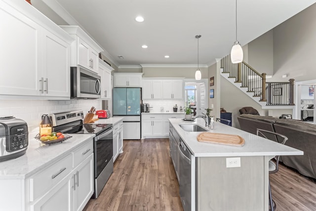 1446 Millstone Creek Rd, Lascassas, TN 37085 - kitchen with appliances with stainless steel finishes, open floor plan, crown molding, backsplash, and white cabinets