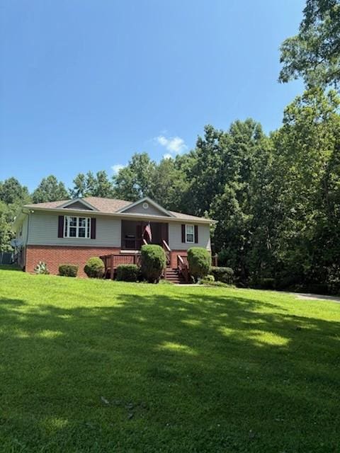 1134 Pee Dee Branch Rd, Cottontown, TN 37048 - view of front of property with a front yard, brick siding, and covered porch