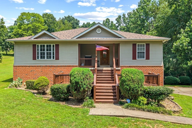 1134 Pee Dee Branch Rd, Cottontown, TN 37048 - view of front facade with brick siding, a front lawn, and covered porch