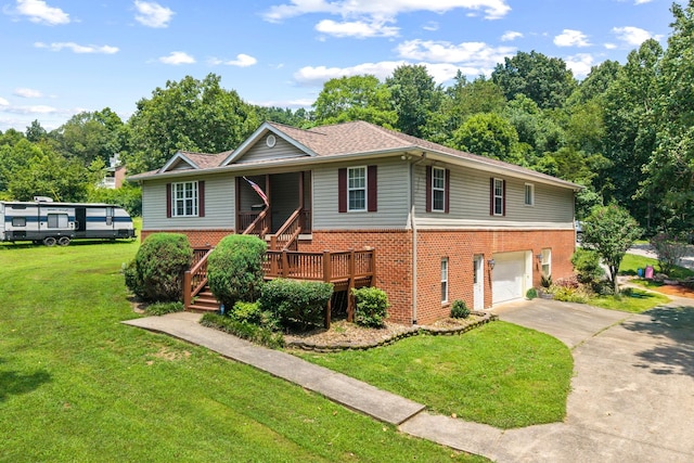 1134 Pee Dee Branch Rd, Cottontown, TN 37048 - view of front facade with brick siding, concrete driveway, a garage, and a front lawn