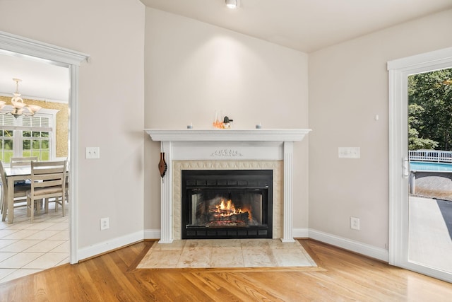 1134 Pee Dee Branch Rd, Cottontown, TN 37048 - detailed view of a fireplace, a chandelier, and wood finished floors