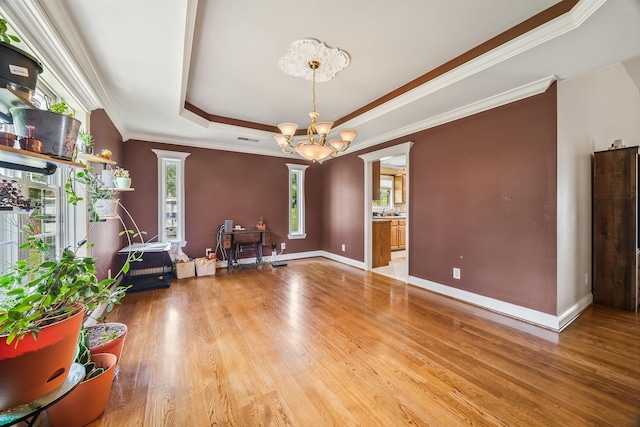 1134 Pee Dee Branch Rd, Cottontown, TN 37048 - living room with a chandelier, a raised ceiling, wood finished floors, crown molding, and ornate columns