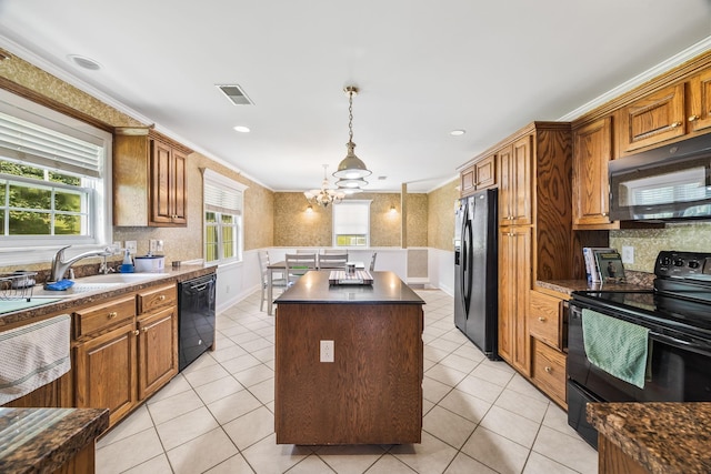 1134 Pee Dee Branch Rd, Cottontown, TN 37048 - kitchen with black appliances, a center island, wainscoting, a chandelier, and dark countertops
