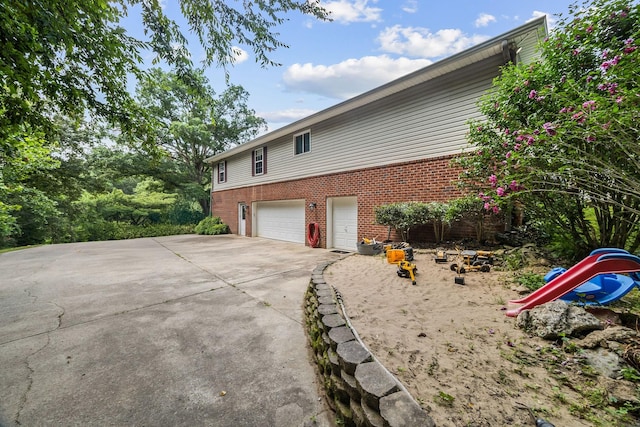 1134 Pee Dee Branch Rd, Cottontown, TN 37048 - view of home's exterior featuring a garage, brick siding, and concrete driveway