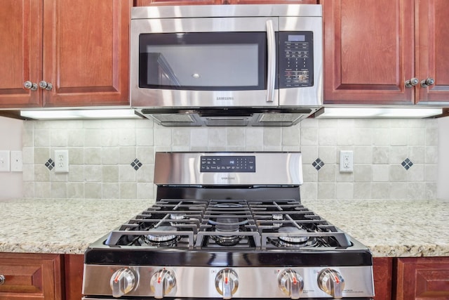 511 Derby Downs, Lebanon, TN 37087 - kitchen featuring stainless steel appliances, tasteful backsplash, and light stone counters