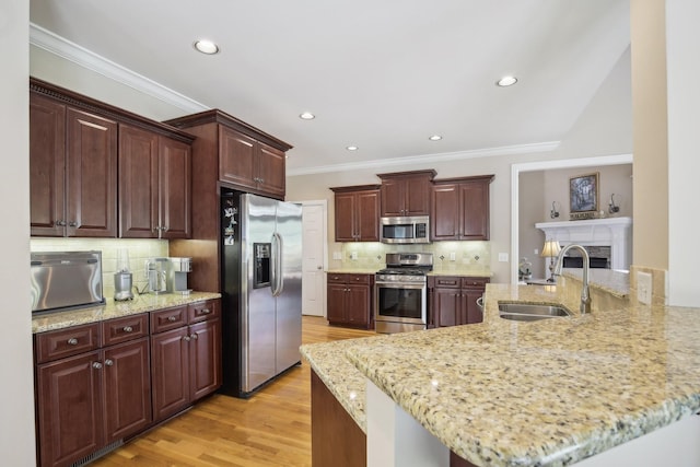 511 Derby Downs, Lebanon, TN 37087 - kitchen with stainless steel appliances, crown molding, light wood-style flooring, backsplash, and light stone counters