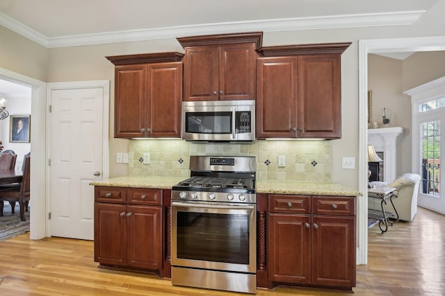 511 Derby Downs, Lebanon, TN 37087 - kitchen with appliances with stainless steel finishes, light wood-style flooring, light stone countertops, and crown molding