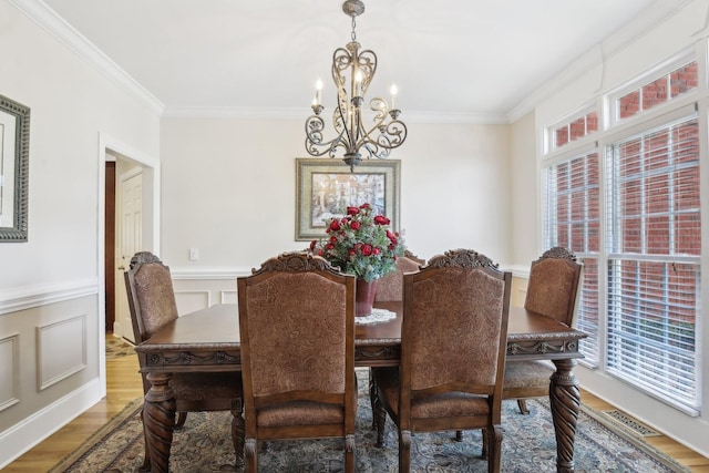 511 Derby Downs, Lebanon, TN 37087 - dining area featuring a chandelier, ornamental molding, wood finished floors, a decorative wall, and wainscoting