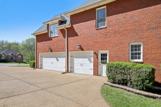 511 Derby Downs, Lebanon, TN 37087 - back of house featuring an attached garage, concrete driveway, and brick siding