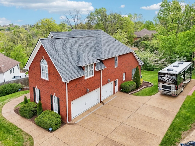 511 Derby Downs, Lebanon, TN 37087 - view of home's exterior with an attached garage, driveway, brick siding, a shingled roof, and a yard