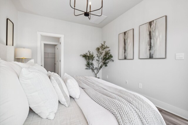 541 Tulip Springs Rd, Hermitage, TN 37076 - bedroom with a chandelier, wood finished floors, a walk in closet, and a closet