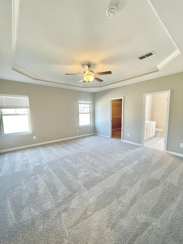 404 Wren Way, Spring Hill, TN 37174 - unfurnished bedroom featuring carpet floors, a spacious closet, a raised ceiling, ensuite bathroom, and a ceiling fan