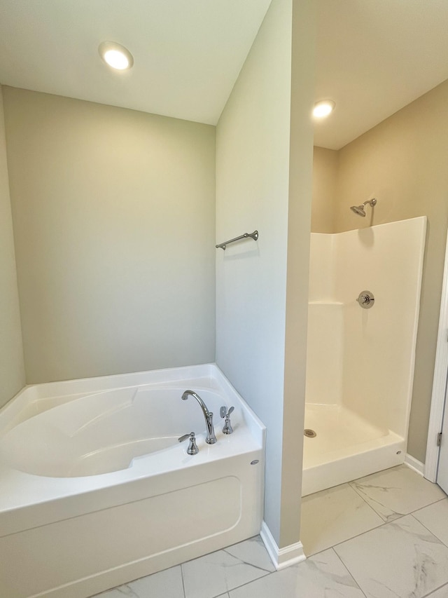 404 Wren Way, Spring Hill, TN 37174 - bathroom featuring marble look tiles, a bath, a shower stall, and recessed lighting