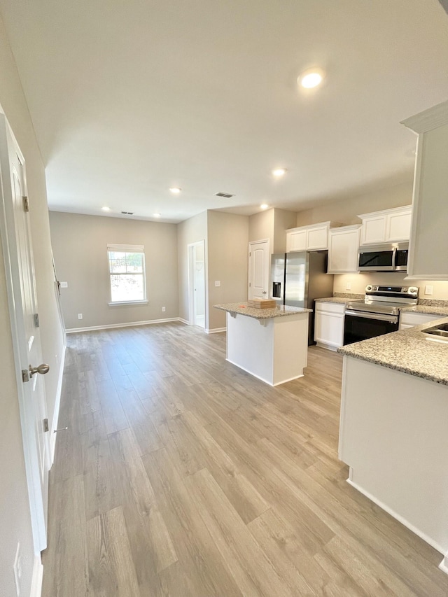 404 Wren Way, Spring Hill, TN 37174 - kitchen with appliances with stainless steel finishes, open floor plan, a center island, light wood-style floors, and white cabinetry