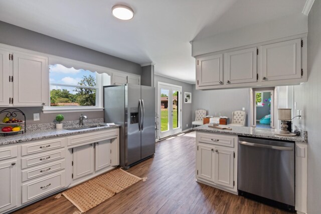 100 Eleazer Dr, Dickson, TN 37055 - kitchen featuring appliances with stainless steel finishes, white cabinets, dark wood-type flooring, and light stone countertops