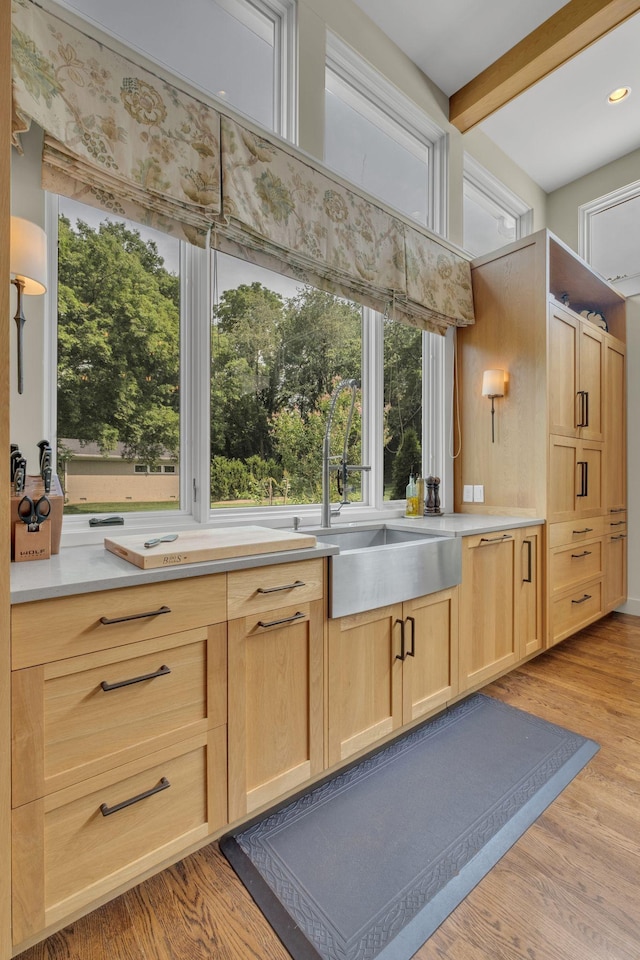 111 Hardingwoods Pl, Nashville, TN 37205 - kitchen featuring light brown cabinetry, light countertops, healthy amount of natural light, light wood-style floors, and beamed ceiling
