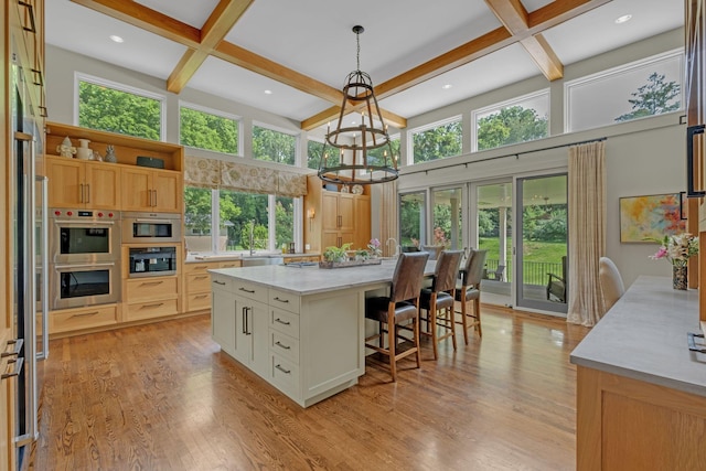 111 Hardingwoods Pl, Nashville, TN 37205 - kitchen with open shelves, beam ceiling, a breakfast bar, a chandelier, and coffered ceiling