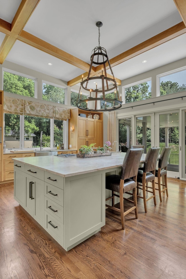 111 Hardingwoods Pl, Nashville, TN 37205 - kitchen featuring beam ceiling, wood finished floors, a spacious island, a chandelier, and decorative light fixtures