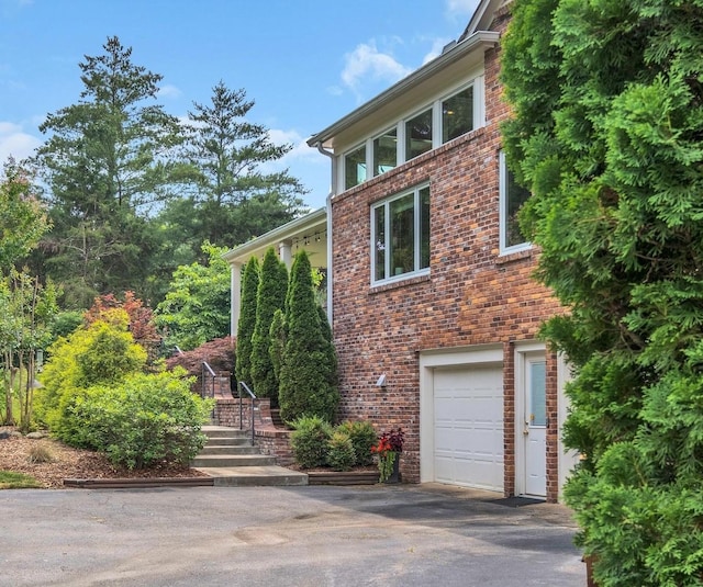 111 Hardingwoods Pl, Nashville, TN 37205 - view of property exterior featuring an attached garage, brick siding, and driveway
