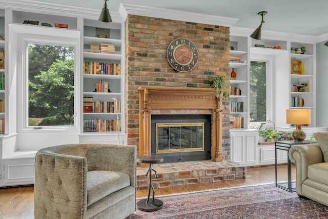 111 Hardingwoods Pl, Nashville, TN 37205 - living room with wood finished floors, a brick fireplace, built in shelves, and crown molding