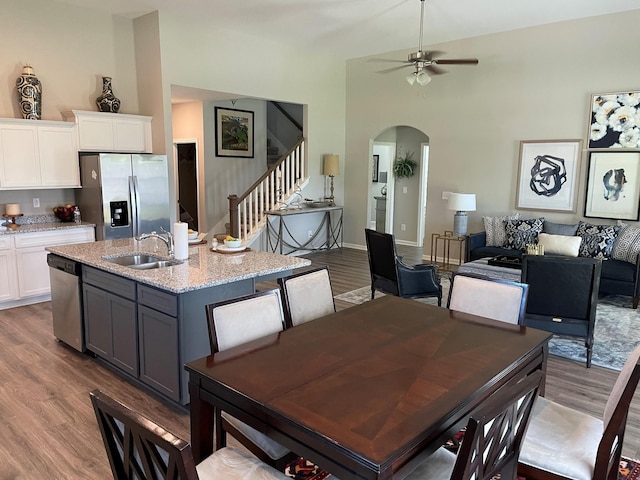 423 Wren Way, Spring Hill, TN 37174 - dining area with arched walkways, wood finished floors, stairway, a ceiling fan, and vaulted ceiling