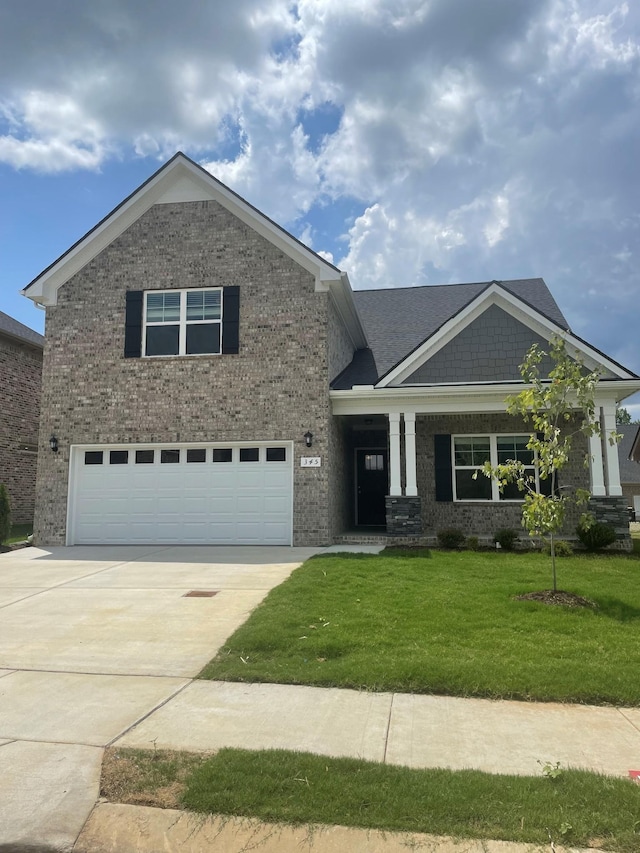423 Wren Way, Spring Hill, TN 37174 - craftsman house with an attached garage, driveway, brick siding, and a front yard