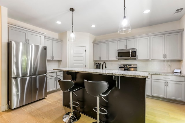 3319 Old Hickory Blvd Unit 17, Old Hickory, TN 37138 - kitchen featuring appliances with stainless steel finishes, gray cabinets, light wood-style flooring, backsplash, and hanging light fixtures