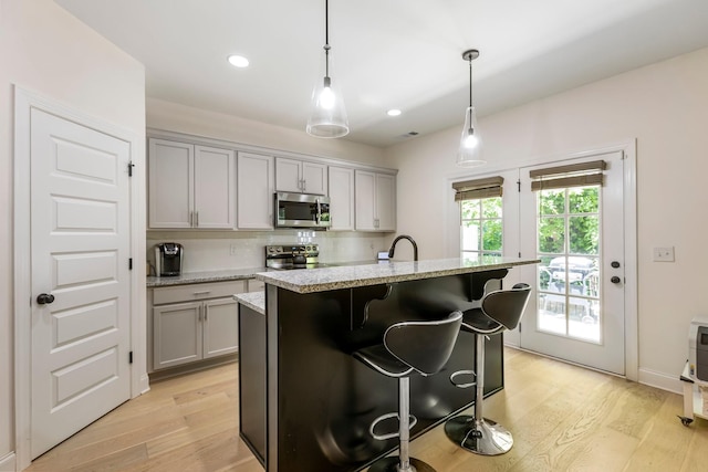 3319 Old Hickory Blvd Unit 17, Old Hickory, TN 37138 - kitchen with stainless steel microwave, range with electric stovetop, gray cabinetry, light wood-style flooring, and recessed lighting