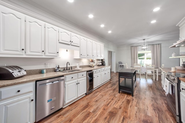 723 Alecia Page Cv, Humboldt, TN 38343 - kitchen featuring appliances with stainless steel finishes, beverage cooler, crown molding, white cabinets, and light wood-type flooring