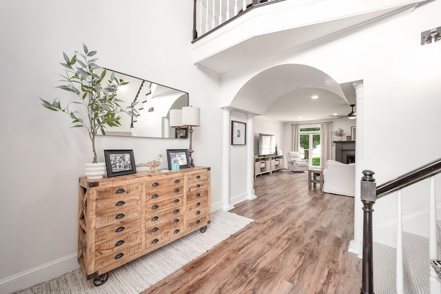 723 Alecia Page Cv, Humboldt, TN 38343 - foyer with arched walkways, ornate columns, ceiling fan, wood finished floors, and a towering ceiling