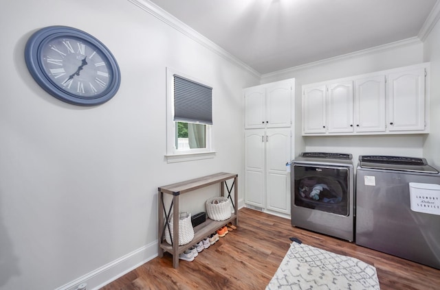 723 Alecia Page Cv, Humboldt, TN 38343 - laundry room featuring cabinet space, washing machine and dryer, ornamental molding, and wood finished floors