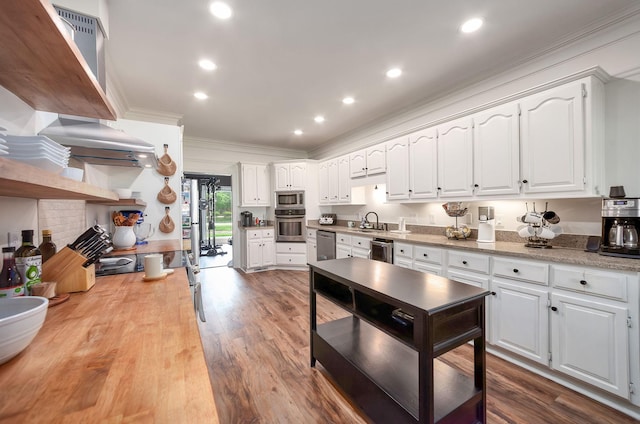 723 Alecia Page Cv, Humboldt, TN 38343 - kitchen with stainless steel appliances, crown molding, white cabinets, light countertops, and dark wood-style floors