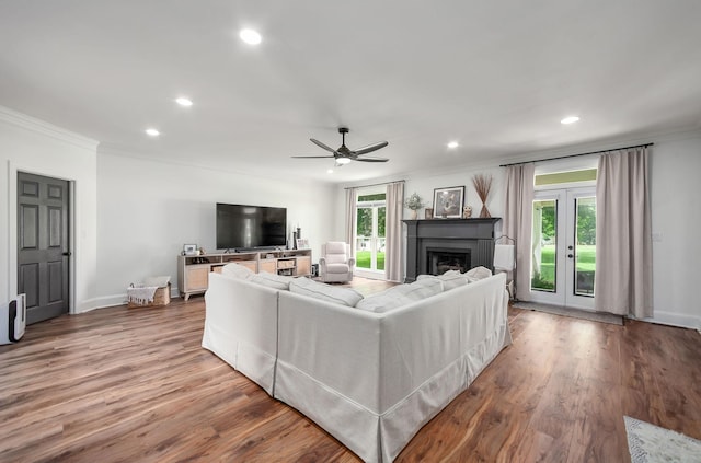 723 Alecia Page Cv, Humboldt, TN 38343 - living area featuring ornamental molding, recessed lighting, wood finished floors, a fireplace, and french doors