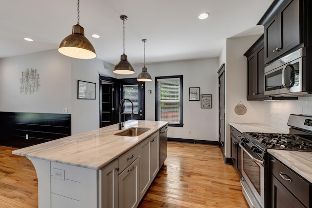 2136 Buena Vista Pike Unit B, Nashville, TN 37218 - kitchen featuring appliances with stainless steel finishes, backsplash, light wood-style floors, light stone countertops, and recessed lighting
