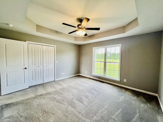 4977 Little Dry Creek Rd, Pulaski, TN 38478 - unfurnished bedroom with a raised ceiling, carpet floors, a closet, and a ceiling fan