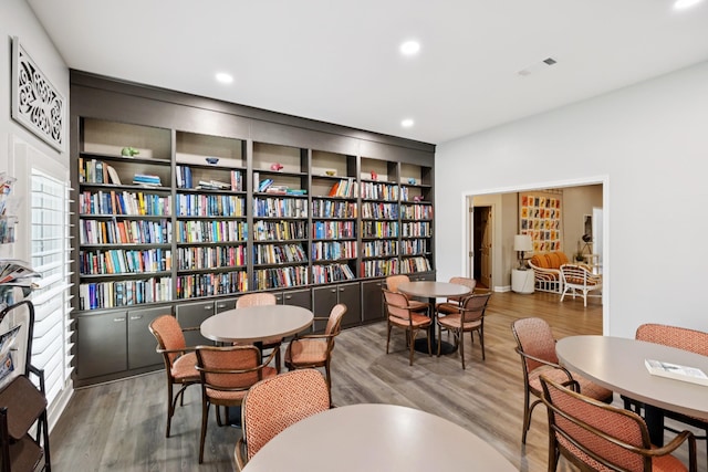 438 Siena Dr, Nashville, TN 37205 - living area featuring wood finished floors, wall of books, and recessed lighting