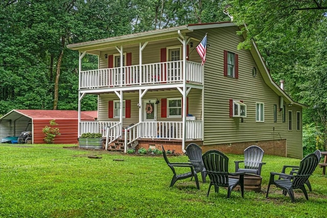 802 Evans Rd, Winchester, TN 37398 - view of front of house with covered porch, a balcony, a fire pit, a detached carport, and a front yard