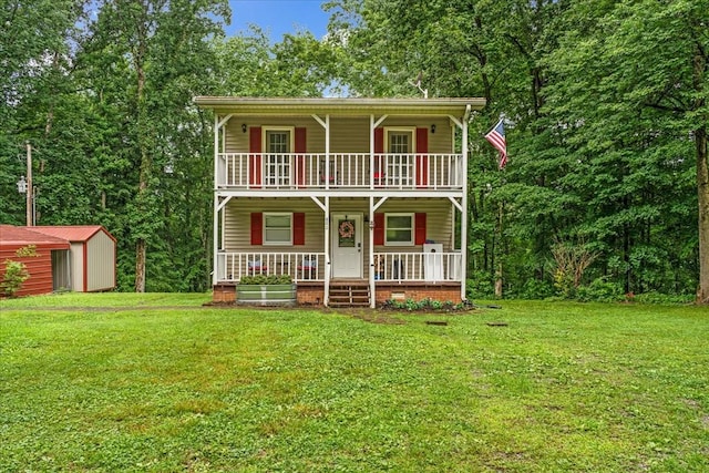 802 Evans Rd, Winchester, TN 37398 - view of front facade with a porch, a balcony, a storage shed, and a front yard