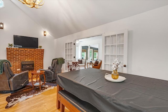 802 Evans Rd, Winchester, TN 37398 - dining space featuring light wood-style floors, vaulted ceiling, french doors, and a fireplace