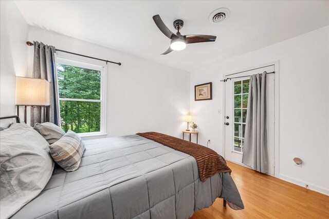 802 Evans Rd, Winchester, TN 37398 - bedroom featuring access to exterior, multiple windows, wood finished floors, and a ceiling fan