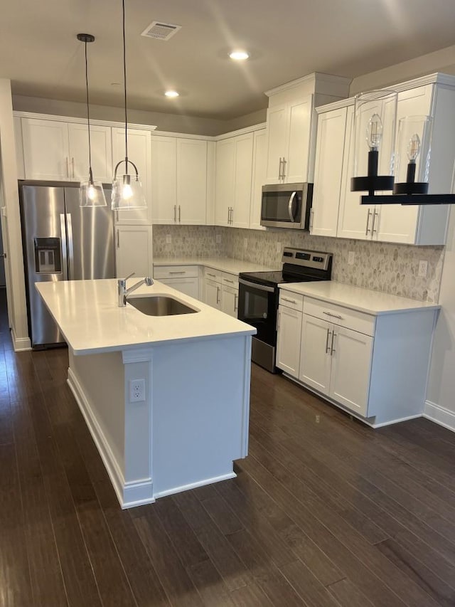 204 Douglas Bend Rd Unit 804, Gallatin, TN 37066 - kitchen featuring stainless steel appliances, dark wood finished floors, white cabinets, decorative backsplash, and pendant lighting